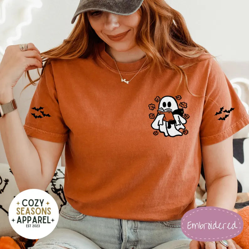 Embroidered Comfort Colors Halloween Book Shirt - Spooky Ghost Reading a Book Holding Black Cat in the Fall with Bat Sleeves