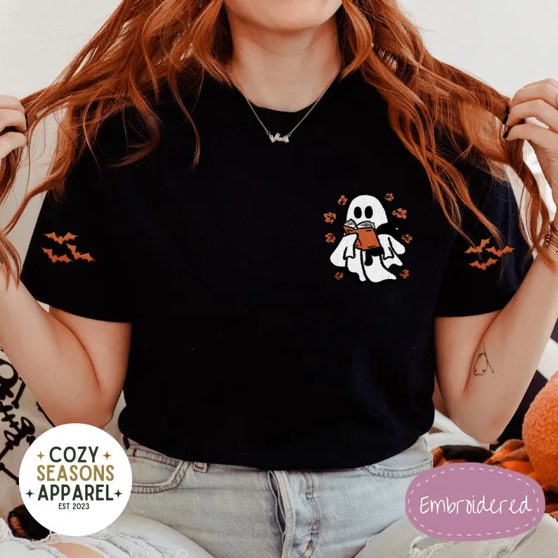 Embroidered Comfort Colors Halloween Book Shirt - Spooky Ghost Reading a Book Holding Black Cat in the Fall with Bat Sleeves